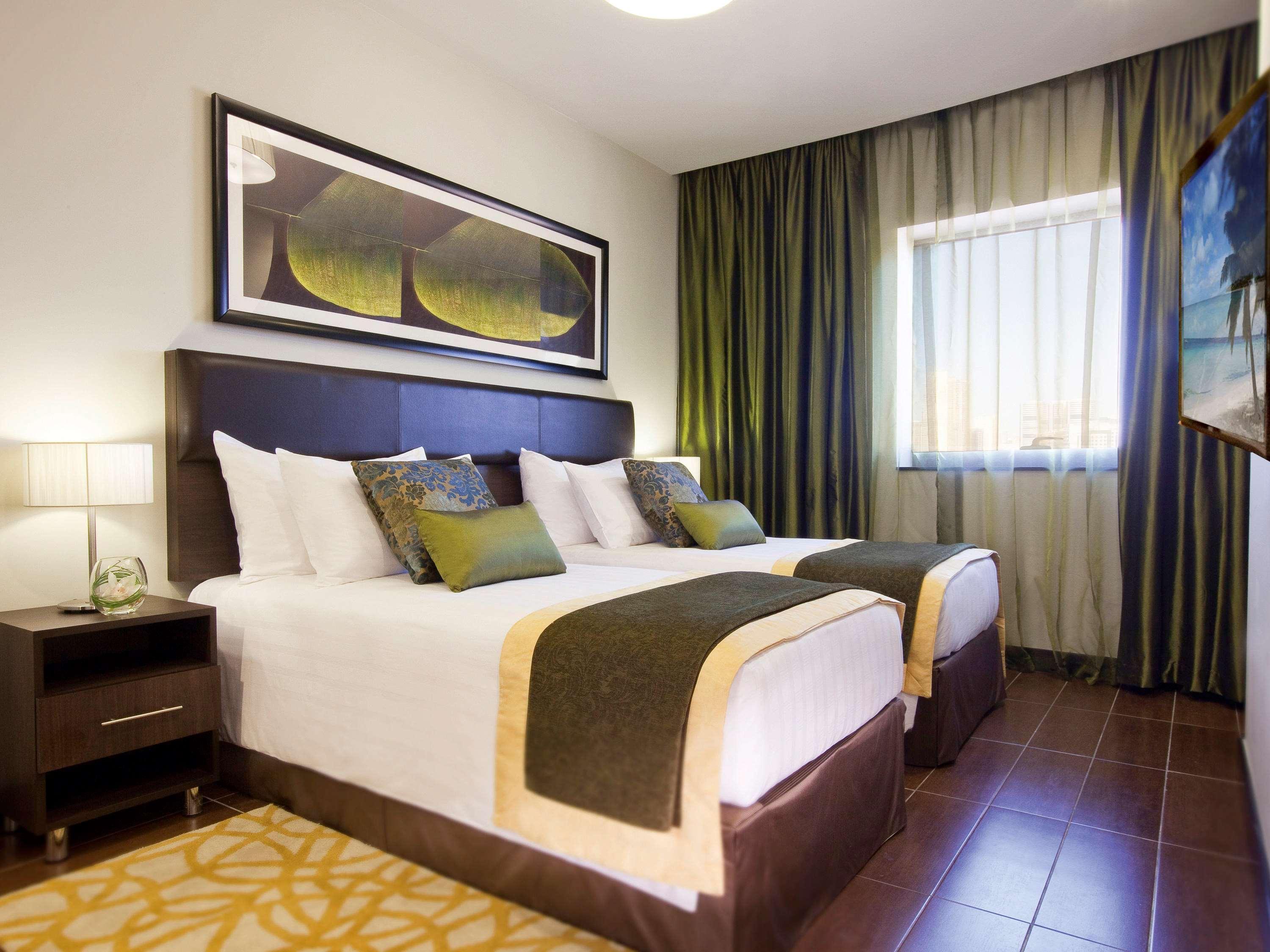 Moevenpick Hotel Apartments Al Mamzar Dubai Bagian luar foto A bedroom at the hotel
