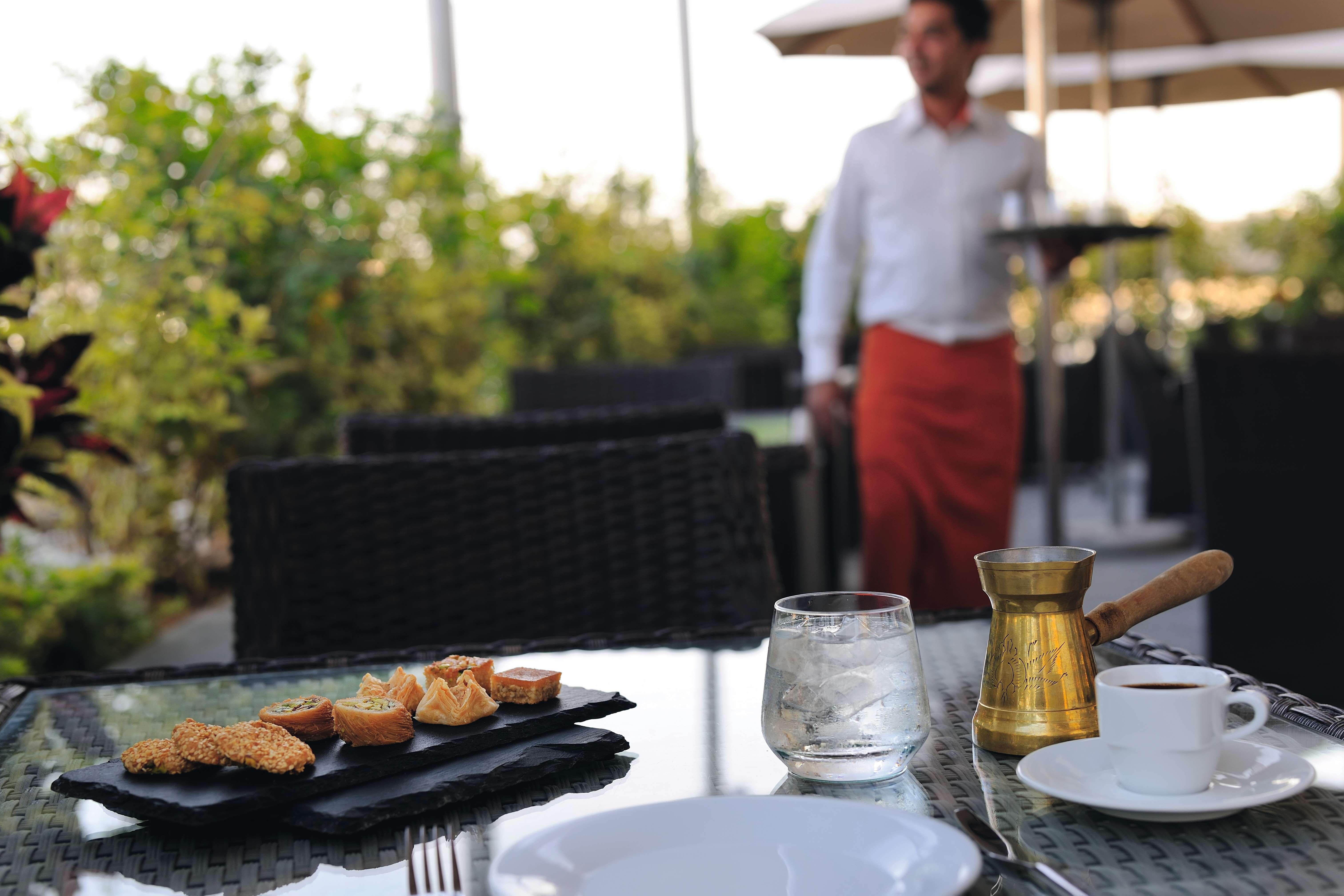 Moevenpick Hotel Apartments Al Mamzar Dubai Bagian luar foto A waiter at work