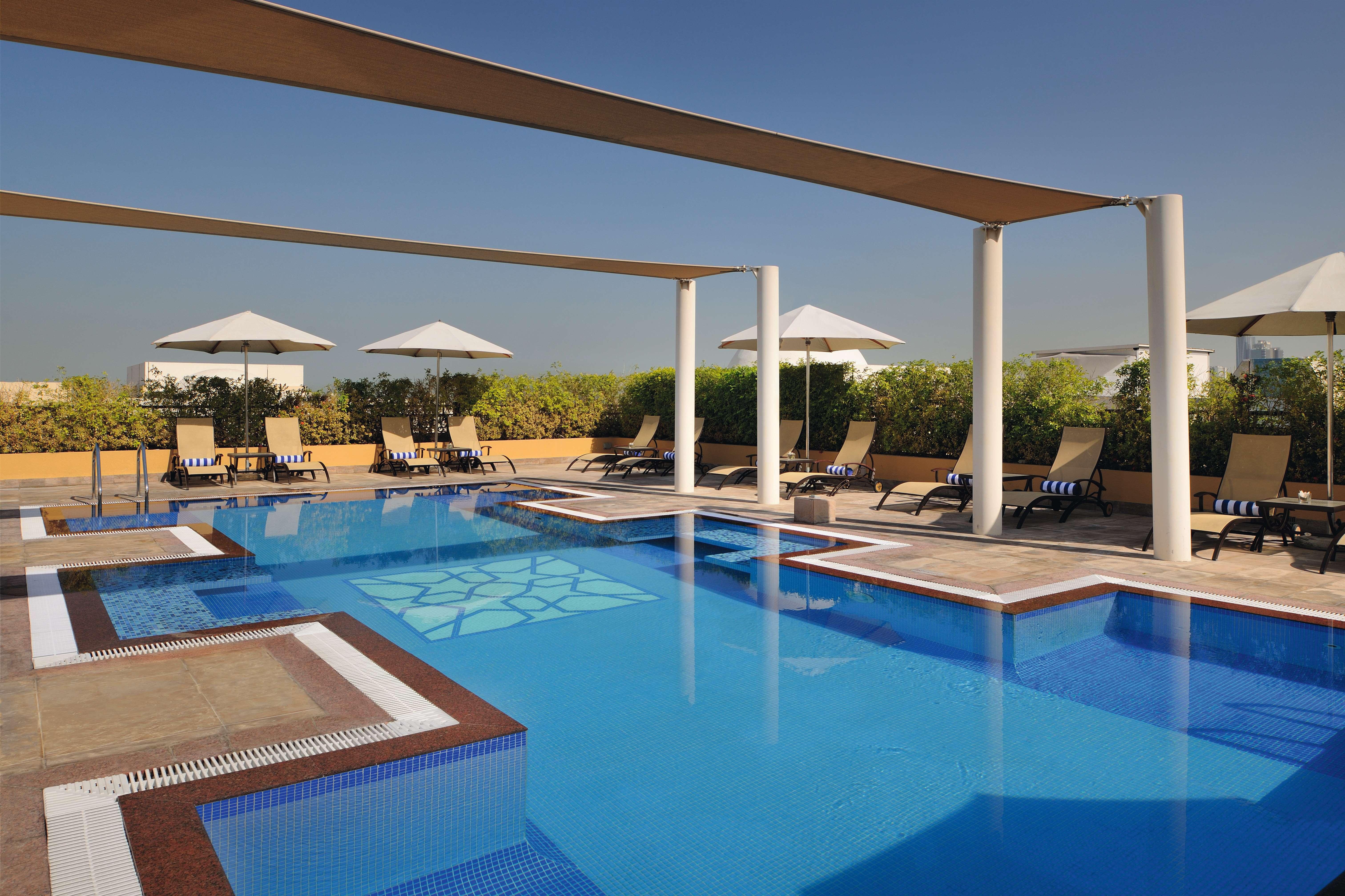 Moevenpick Hotel Apartments Al Mamzar Dubai Bagian luar foto The swimming pool at the hotel