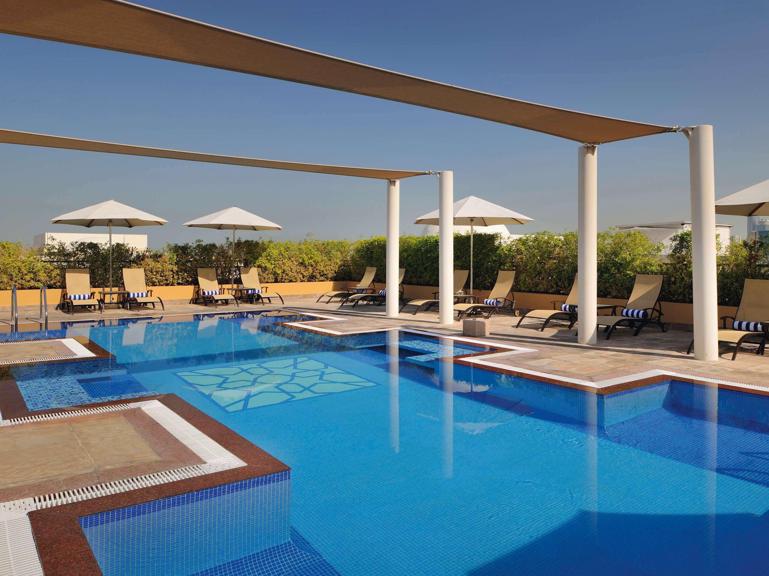 Moevenpick Hotel Apartments Al Mamzar Dubai Bagian luar foto The swimming pool at the hotel