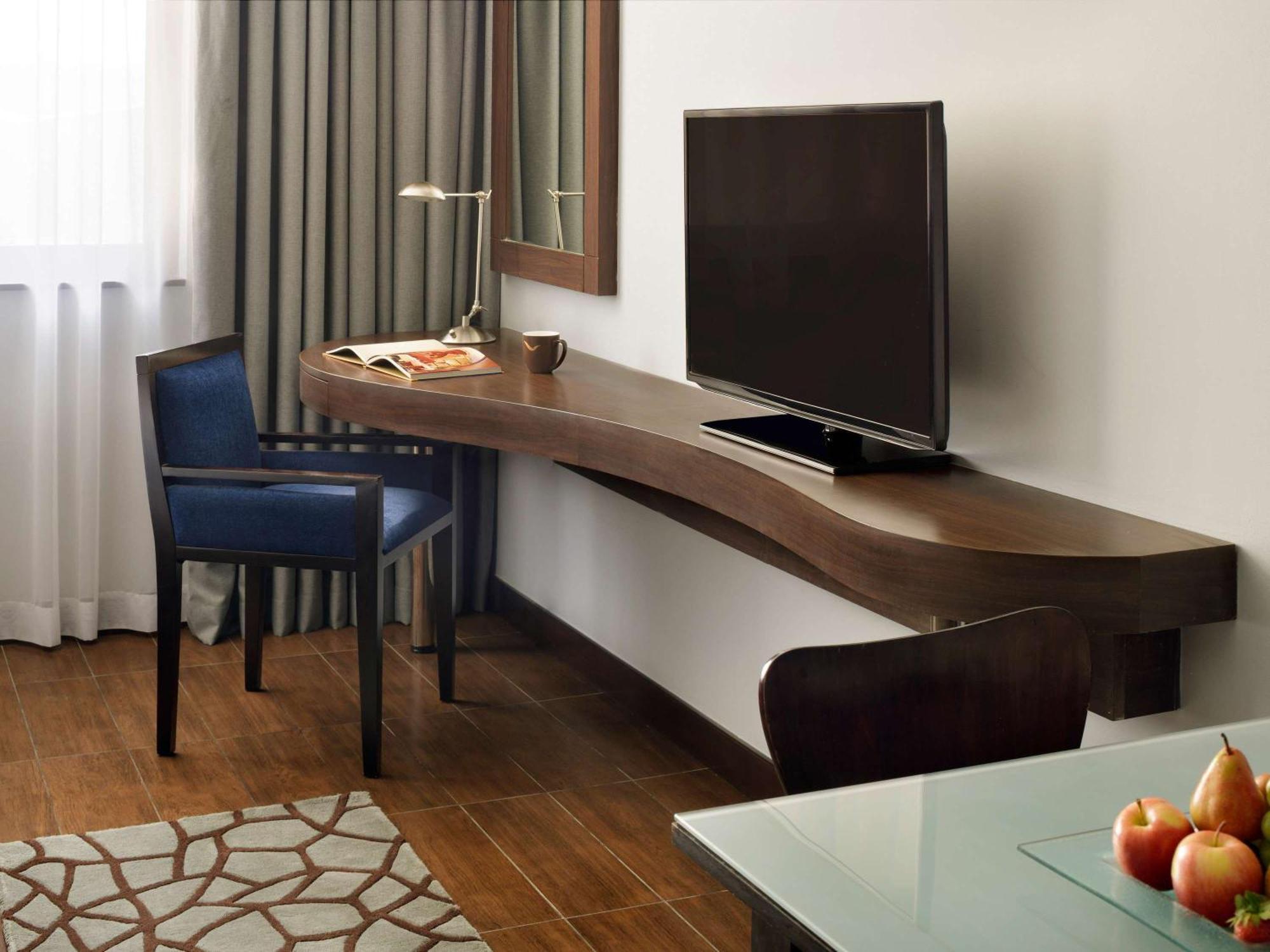 Moevenpick Hotel Apartments Al Mamzar Dubai Bagian luar foto A television in a hotel room