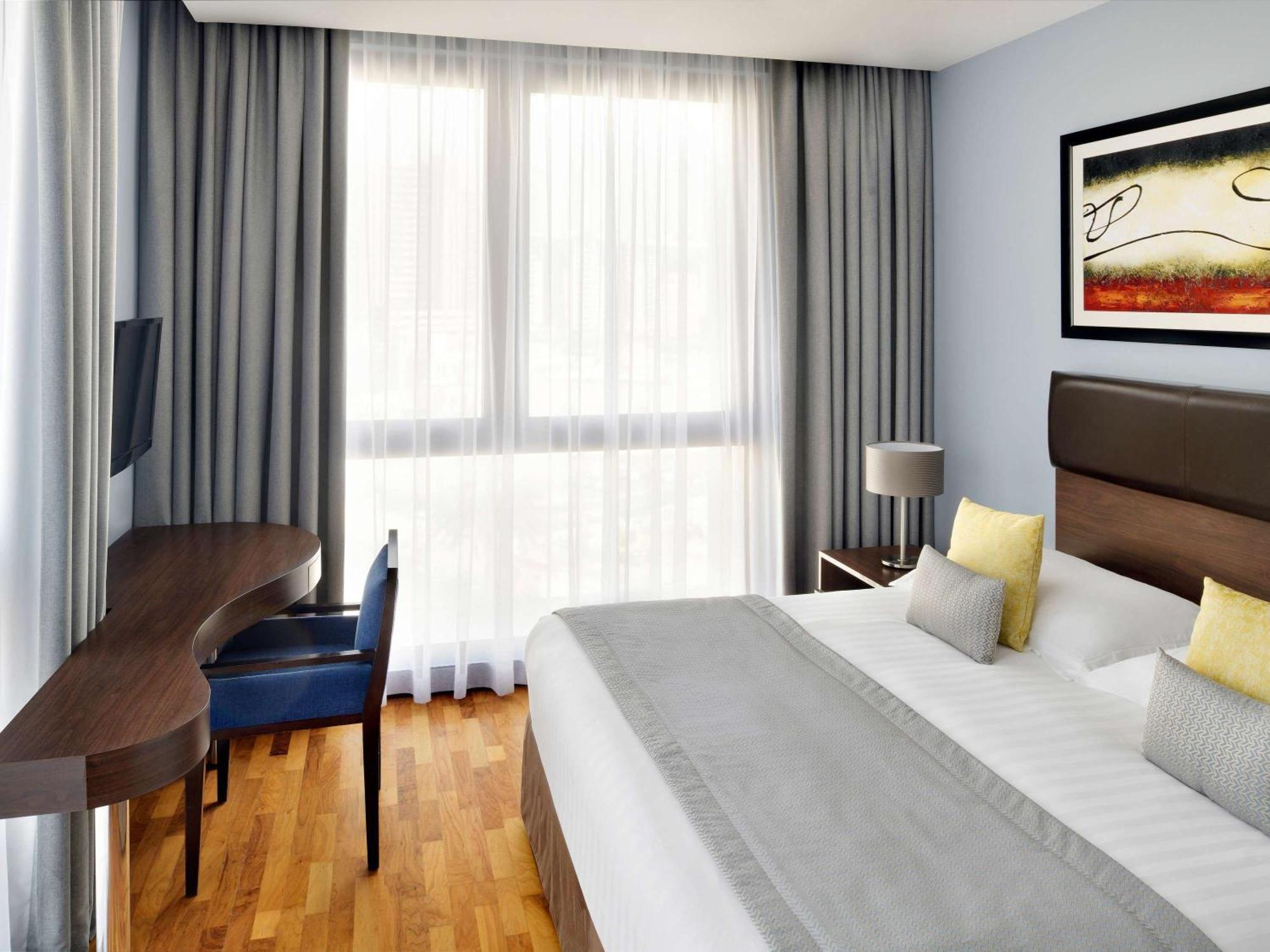 Moevenpick Hotel Apartments Al Mamzar Dubai Bagian luar foto A typical room at the hotel